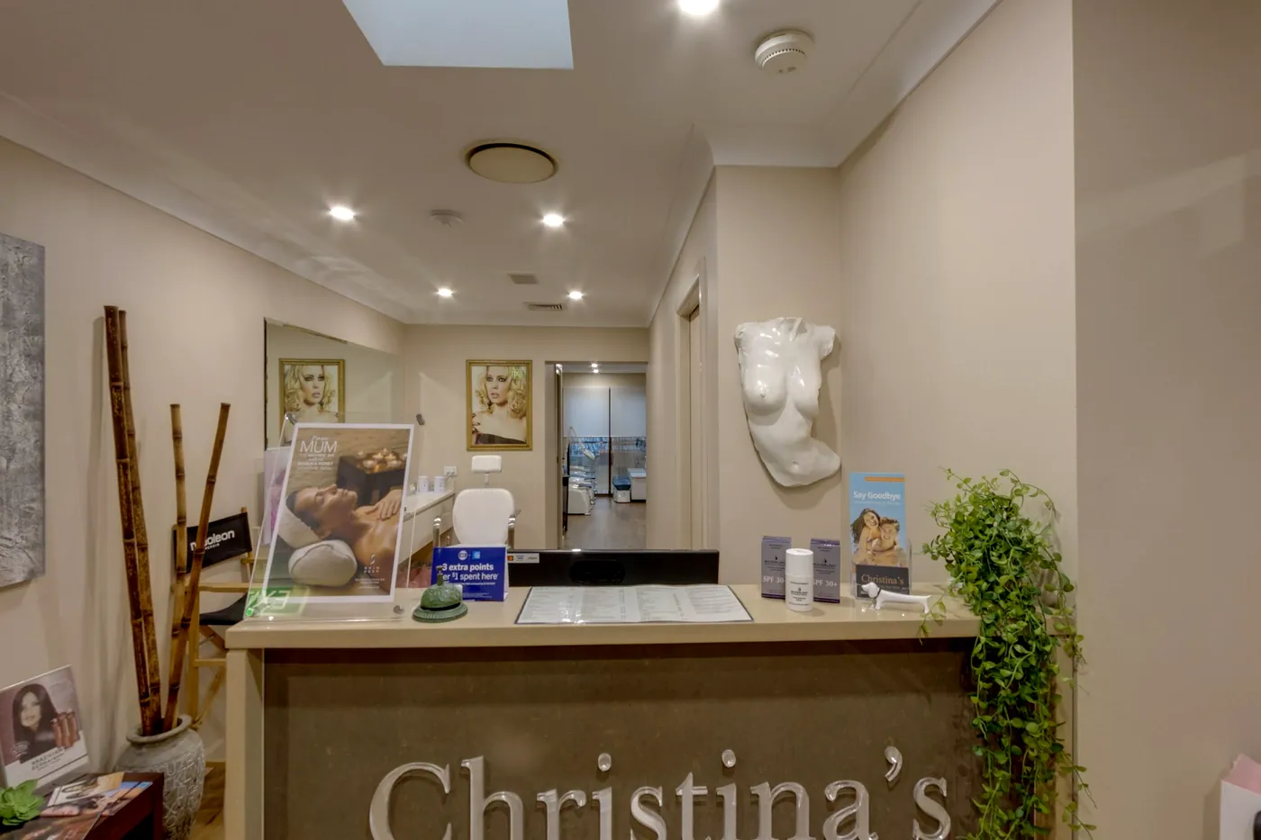 Christina's reception desk with bamboo stems, framed spa prints and a sculpted torso