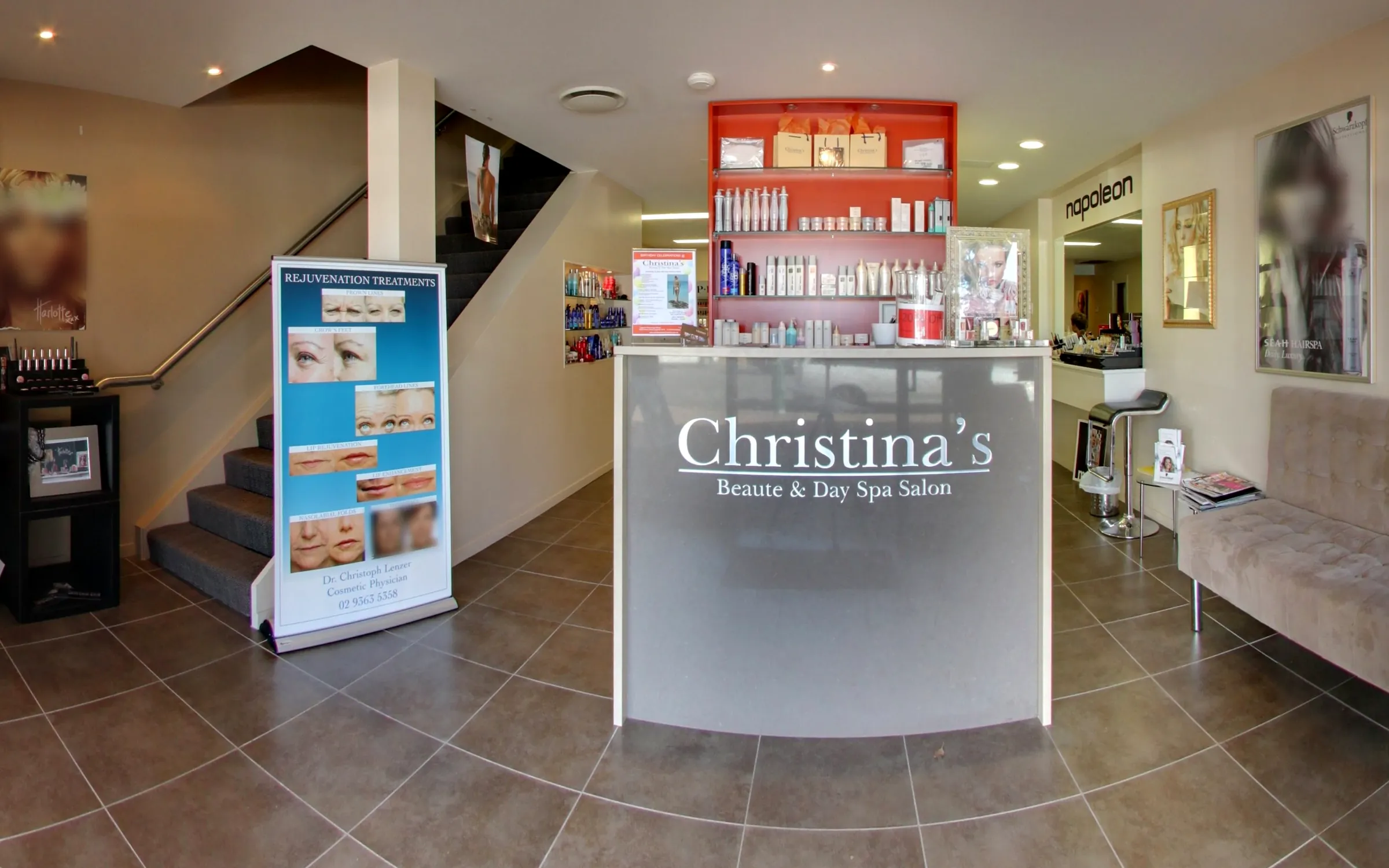 The salon entrance with the frosted Christina's sign and the red product wall